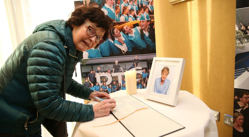 Ruth Barror signs the book. Photo: Stephen Collins/Collins Photos