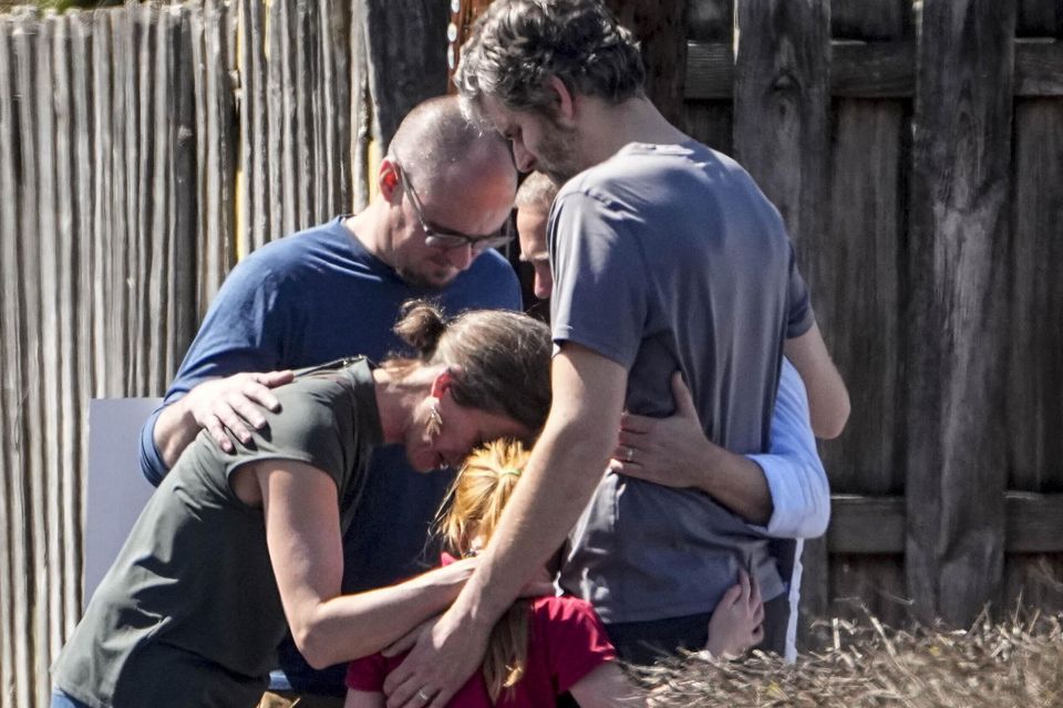 A group prays after the shooting (John Bazemore/AP)