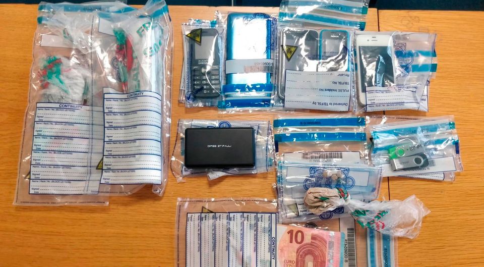 Phones and other items seized in a raids against cartel-linked criminals.