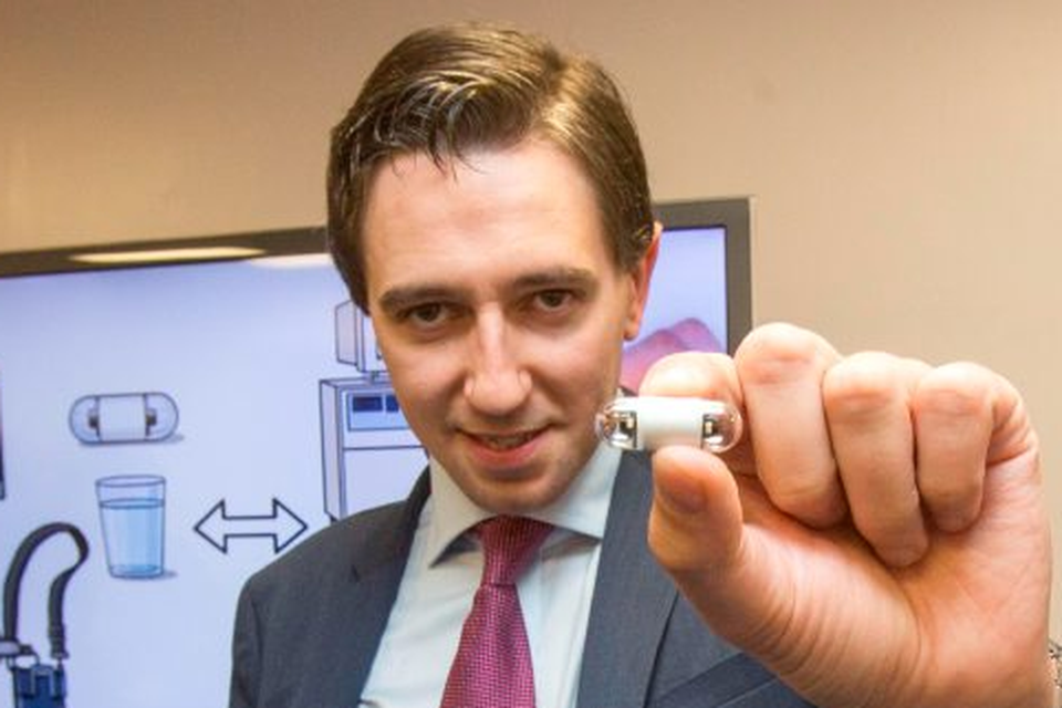 Health Minister Simon Harris holds a tiny camera pill which can be swallowed as an alternative to a colonoscopy. Photo: Mark Condren