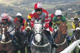 thumbnail: Eventual winners Barry Geraghty and Punjabi (L) approach the second hurdle as Othermix (C), ridden by Paddy Brennan, make the early running in yesterday's Champion Hurdle