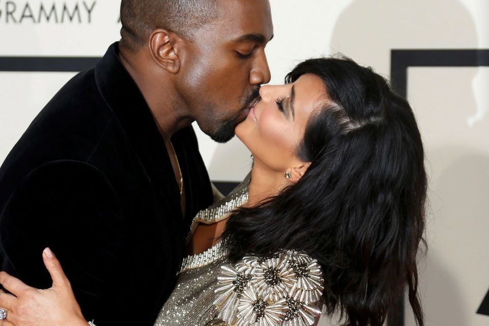 Kanye West and Kim Kardashian kiss on arrival at the 57th annual Grammy Awards in Los Angeles, California February 8, 2015