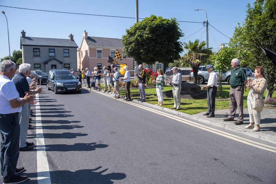 The late Jo Jo Barrett making his way past the iconic Mulchinock’s Corner for the final time on Monday. Friends and members of the Austin Stacks GAA Club lined the route. Photo by Domnick Walsh.