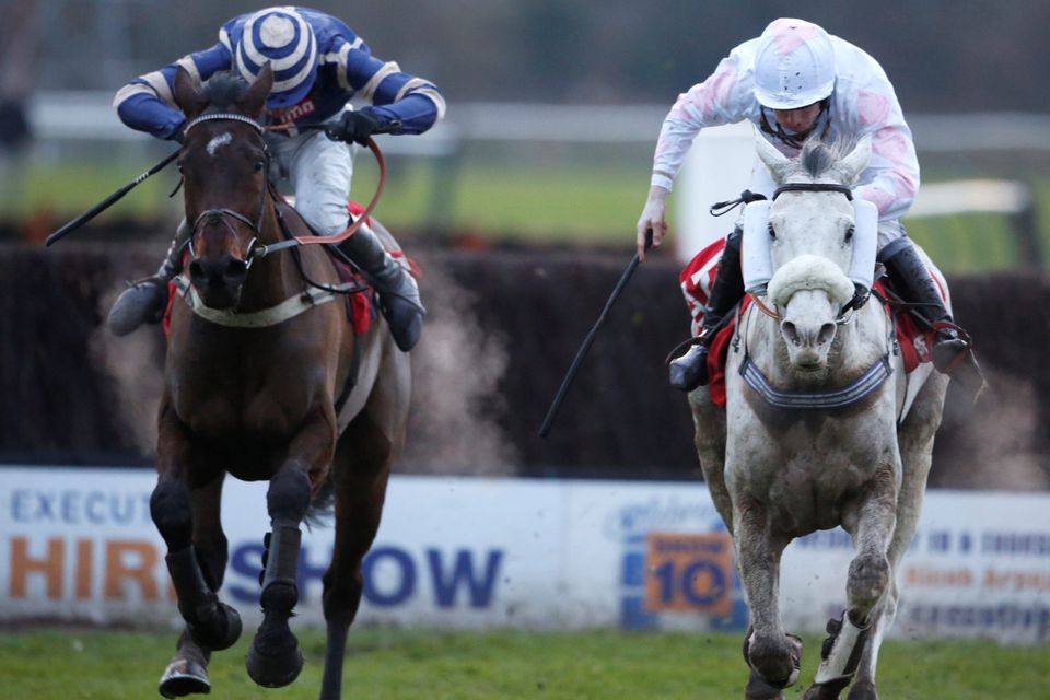 Charlie Poste riding Russe Blanc (right) clear the last to win The Betfred Classic Steeple Chase