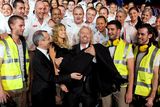 thumbnail: Virgin Blue's Sir Richard Branson (centre R) carries Australian singer Delta Goodrem (C) in 2010