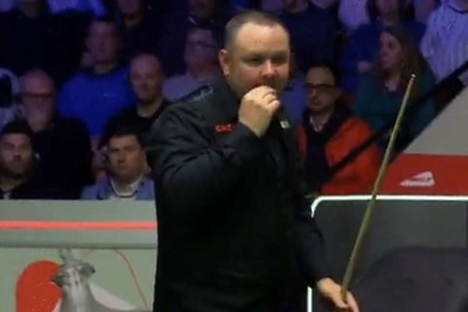 Stephen Maguire appears to eat a fly off the table