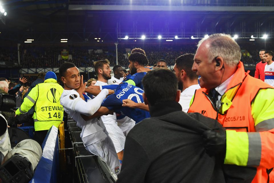 Players clash and fans are restrained after a challenge by Ashley Williams of Everton on Anthony Lopes of Lyon during the UEFA Europa League Group E match between Everton FC and Olympique Lyon at Goodison Park on October 19, 2017 in Liverpool, United Kingdom.  (Photo by Ross Kinnaird/Getty Images)