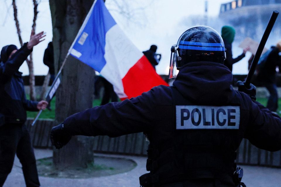 Protesters and police clash in Lille, France, after the pension reform bill was passed. Photo: Reuters/Pascal Rossignol