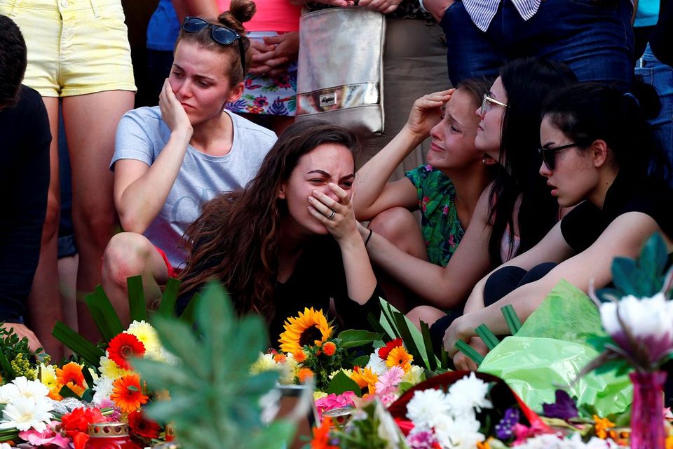 Young people mourn outside the Olympia shopping mall in Munich, Germany, the scene of
a mass shooting on Friday Photo: Arnd Wiegmann/Reuters