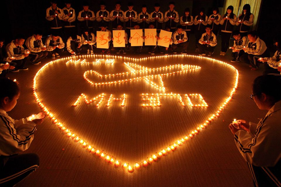 Students from an international school in east China city Zhuji pray for the passengers onboard Malaysia Airlines flight MH370 by lighting candles on March 10, 2014 in Zhuji, China.