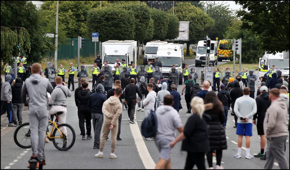 Protesters and gardaí on the Malahide Road in Coolock. Photo: Steve Humphreys