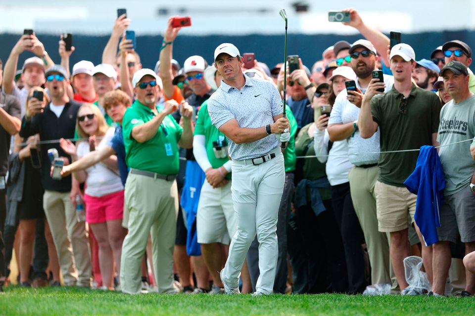 Rory McIlroy plays a second shot on the fourth hole as fans look on during the final round of the 2023 PGA Championship at Oak Hill Country Club on May 21, 2023 in Rochester, New York. (Photo by Andrew Redington/Getty Images)