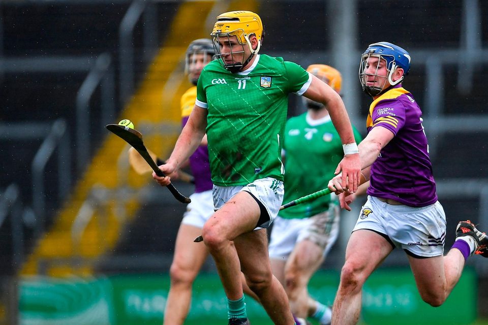 Cathal O'Neill of Limerick on the burst against Kevin Foley of Wexford during the Division 1 Group A match at TUS Gaelic Grounds in Limerick. Photo: Tyler Miller/Sportsfile