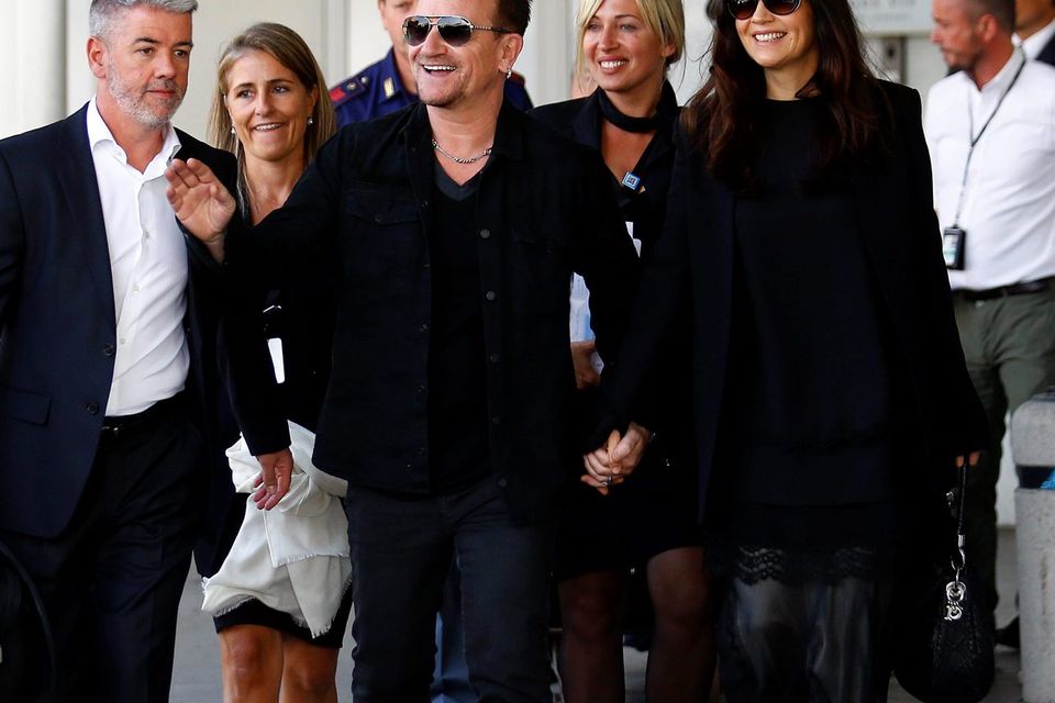 Bono and his wife Ali Hewson arrive to take a taxi boat. Photo credit: REUTERS/Stefano Rellandini