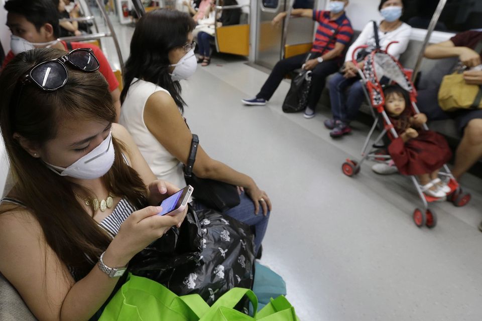 Tourists wear masks as a precaution against Mers on a subway train in Seoul, South Korea. (AP)
