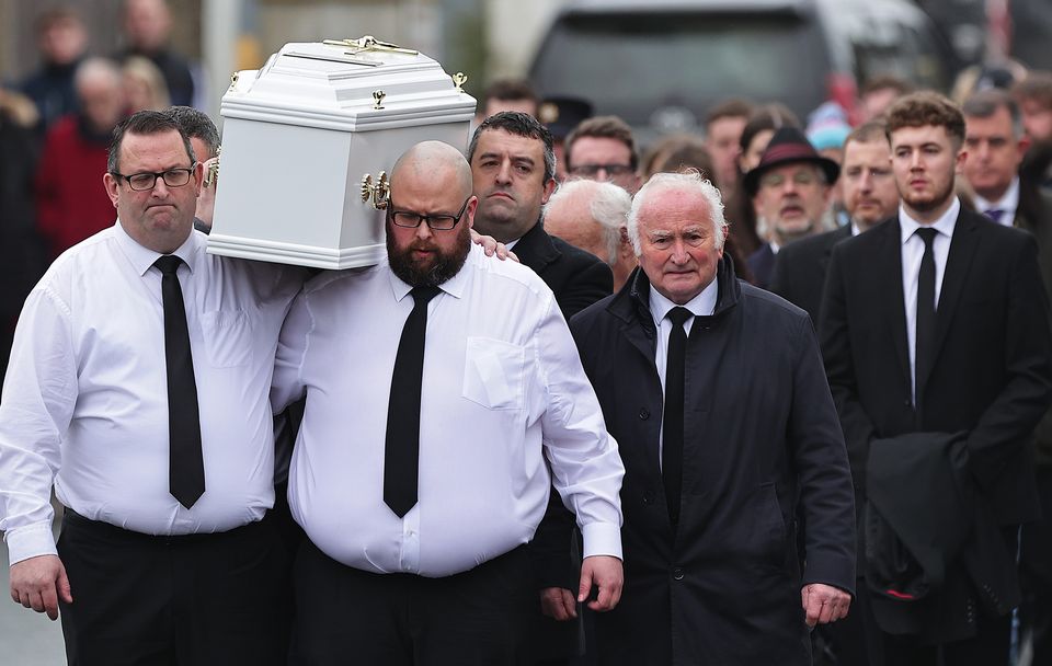 James Healy, centre with beard, carries the remains of his son Matthew. Photo: Gerry Mooney