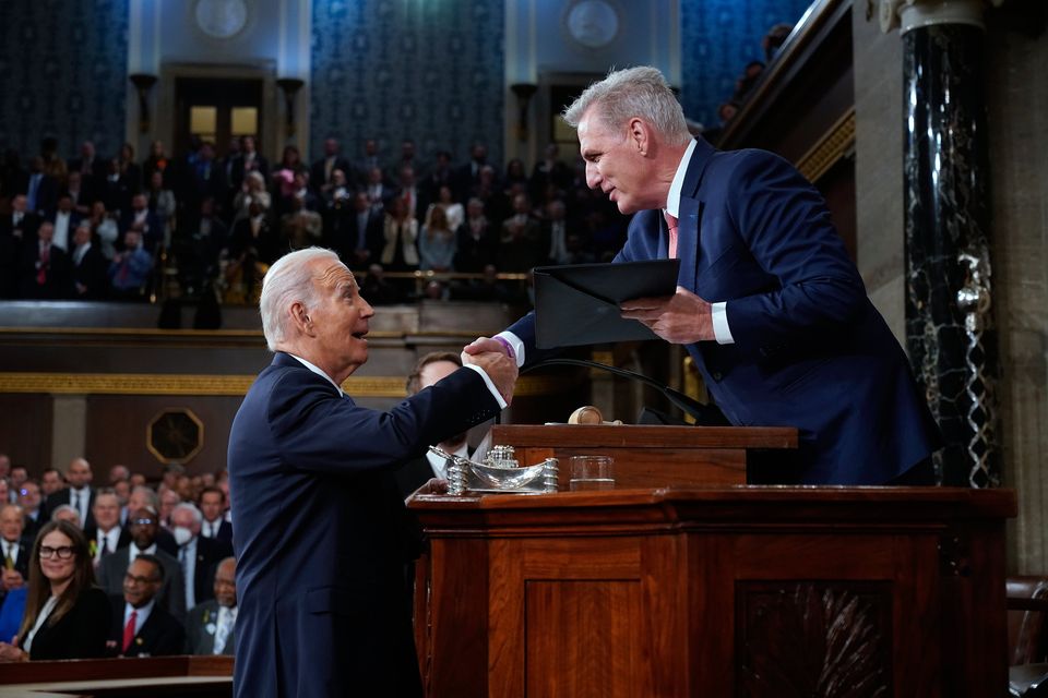 US President Joe Biden shakes hands as he presents a copy of his speech to House Speaker Kevin McCarthy before the State of the Union address in January. Photo: Jacquelyn Martin-Pool/Getty Images