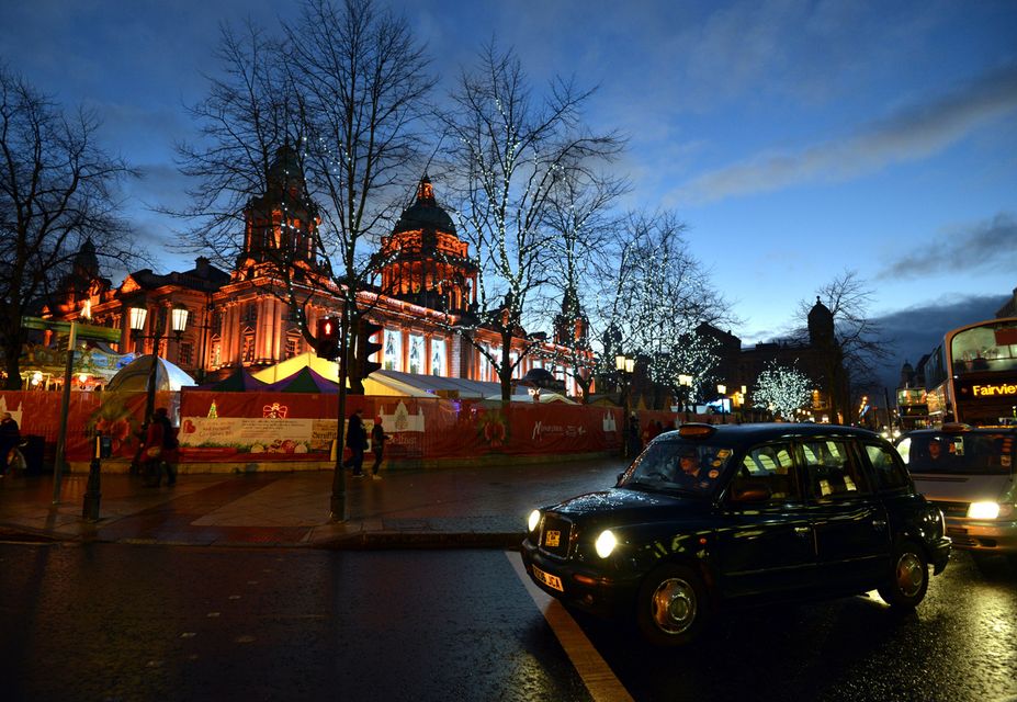 Belfast City Hall at Christmas, with black taxi in the foreground.