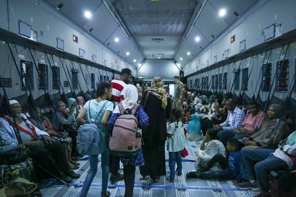 A family board an RAF Plane bound for Cyprus from Sudan. Photo: Arron Hoare