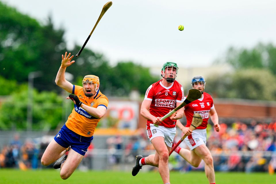 David Fitzgerald of Clare is tackled by Brian Roche of Cork during the Munster GAA Hurling Senior Championship Round 4 match at Cusack Park in Ennis, Clare. Photo by Ray McManus/Sportsfile