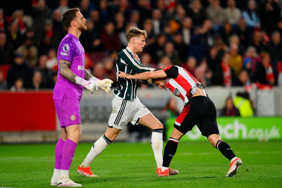 Scott McTominay of Manchester United and Neal Maupay of Brentford clash during the Premier League match at Gtech Community Stadium