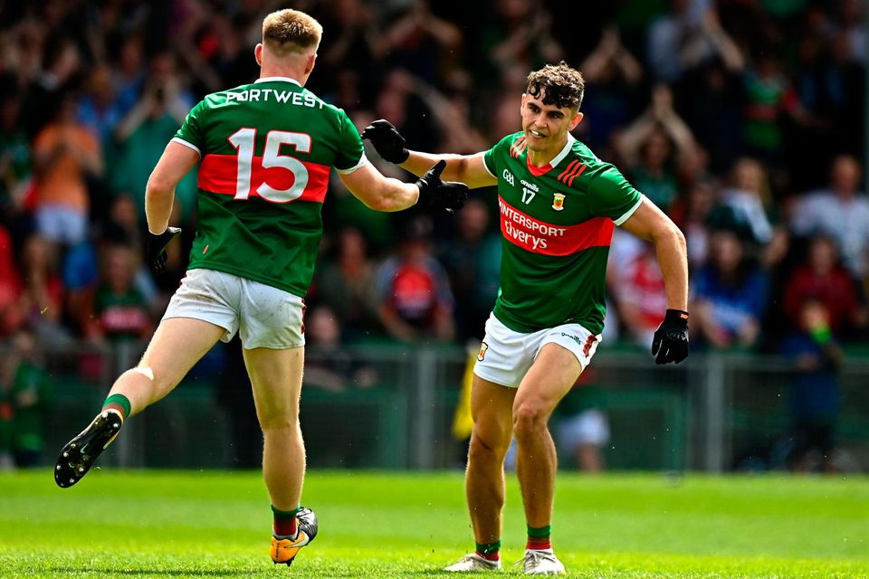 Mayo's Tommy Conroy celebrates with teammate Ryan O'Donoghue after scoring his side's first goal against Cork in Limerick yesterday. Photo: Eóin Noonan/Sportsfile