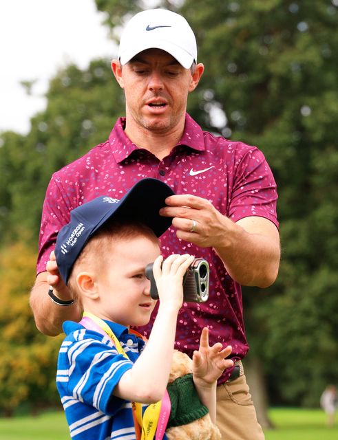 Rory McIlroy and Michael Horgan on the golf course. Photo: Getty