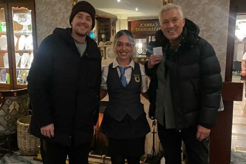 Martin Kemp of Spandu Ballet and his son Roman in the Carrickdale Hotel, pictured staff member Molly Brito. Picture: Carrickdale Hotel/Facebook