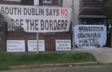 Banners placed on the railings at Minister Roderic O'Gorman's house by masked individuals aligned to the far right