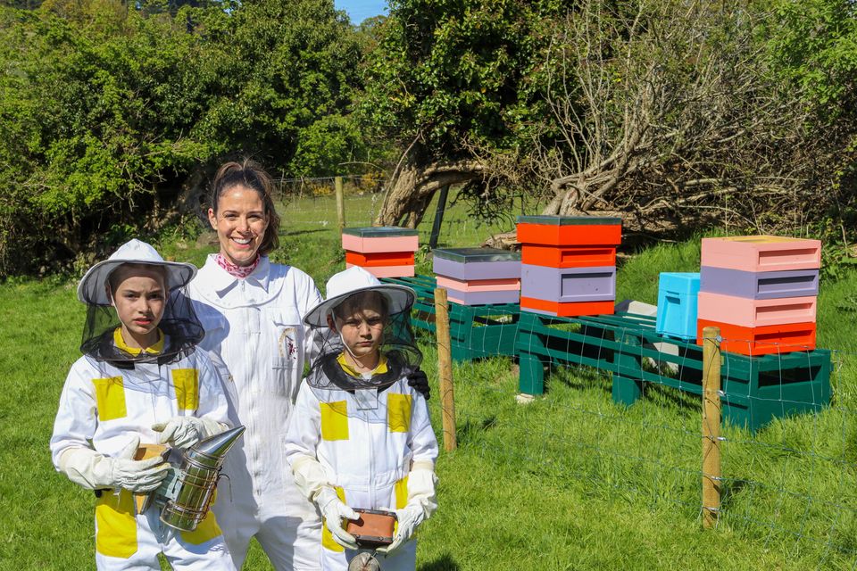 Zach, Yvonne and Archie Johnston at their apiary at home.