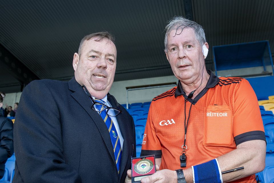 Wicklow GAA Chairman Damien Byrne presents match referee Paul Gahan with a special medal after the Junior 'A' hurling championship final. 