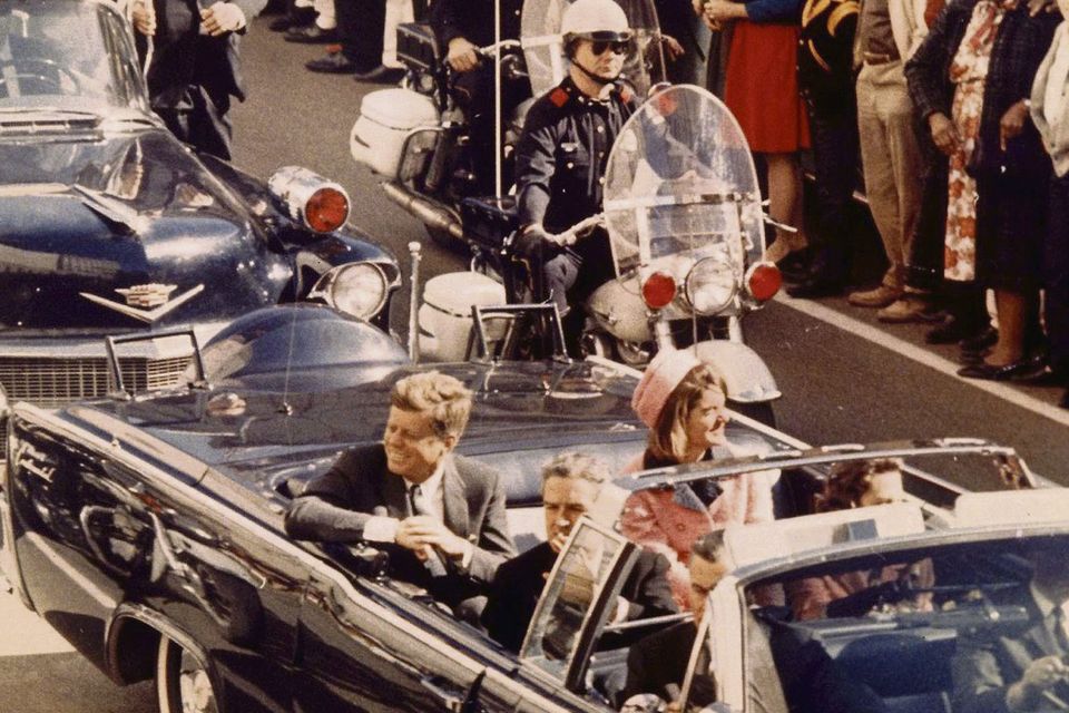 MINUTES FROM DEATH: Kennedy and his wife Jackie ride through Dallas