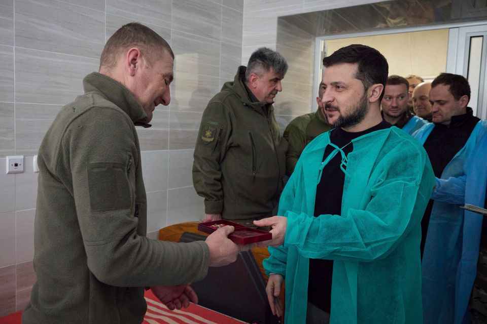 Volodymyr Zelensky awards a soldier in hospital in Donetsk region on Wednesday (Ukrainian Presidential Press Office/AP)