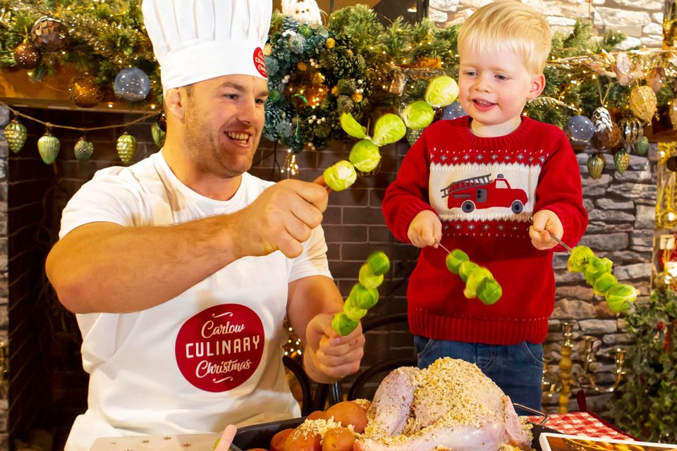 Rugby giant and proud Carlow man, Sean O'Brien, prepares for Carlow Culinary Christmas with three year-old Iarlaith Flannery at The Arbortetum. Photo: Mary Browne