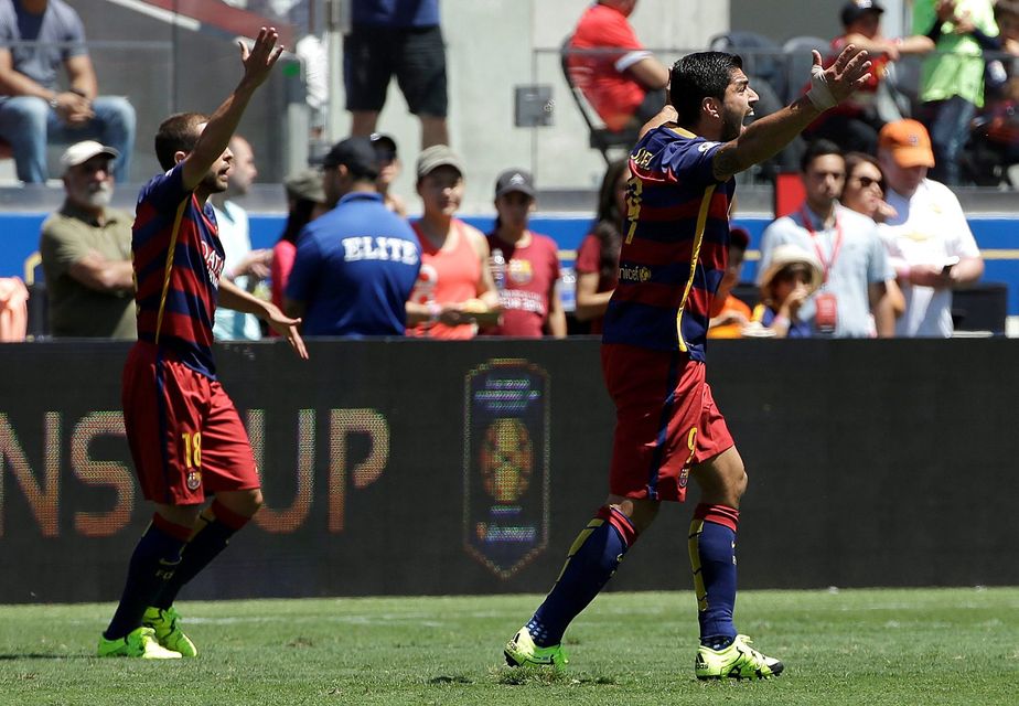 FC Barcelona's Jordi Alba, left, and Luis Suarez (9) react during the second half of an International Champions Cup soccer match against Manchester United in Santa Clara, Calif., Saturday, July 25, 2015. Manchester United won 3-1. (AP Photo/Jeff Chiu)