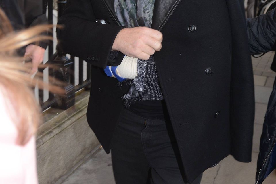 With his injured arm in a sling Bono avoided the annual charity Christmas busking session on Grafton Street this year and instead hung out with celebrity friends at The Cliff Townhouse on St Stephens Green, Dublin, Ireland - 24.12.14.