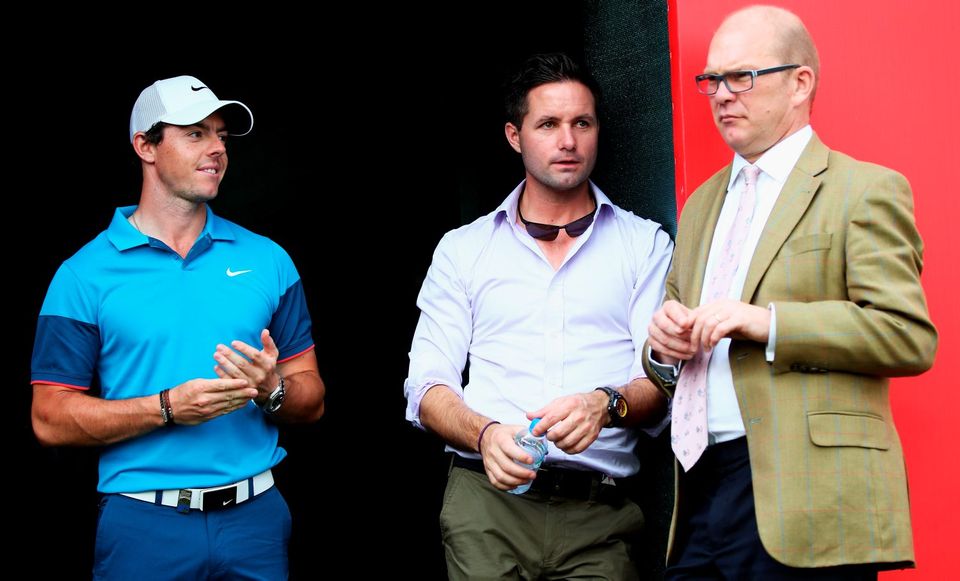 Rory McIlroy of Northern Ireland looks on, with his agent Sean O'Flaherty and Guy Kinnings, global head of golf for IMG after the final day of the Abu Dhabi HSBC Golf Championship at Abu Dhabi Golf Club on January 18, 2015 in Abu Dhabi, United Arab Emirates.  (Photo by Matthew Lewis/Getty Images)