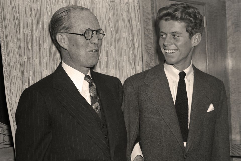 US Ambassador to Great Britain, Joseph P. Kennedy links arms with his son, John Fitzgerald. Photo: Bettmann Archive