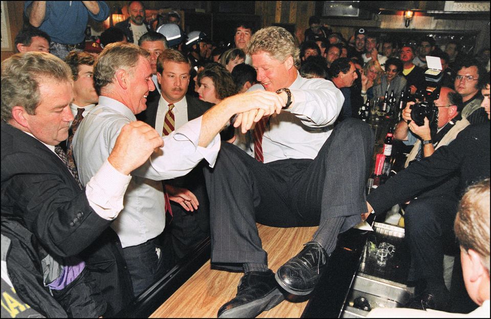 Bill Clinton is hoisted up high during his campaign at the bar