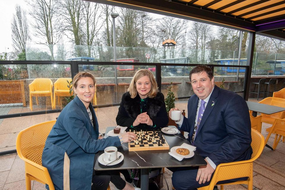 Cathaoirleach of the Killarney Municipal District, Cllr Niall Kelleher enjoying a game of chess with Miriam Kennedy, Head of Wild Atlantic Way / Failte Ireland at the official opening of the Killarney Outdoor Dining Infrastructure at Kenmare Place, Killarney on Wednesday along with Angela McAllen, Killarney Town Manager. Photo by Don MacMonagle