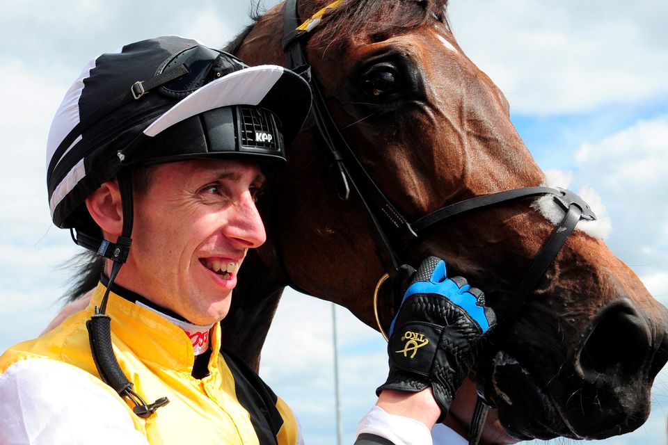 Winning jockey George Baker celebrates with Quest For More after victory in the John Smith's Northumberland Plate
