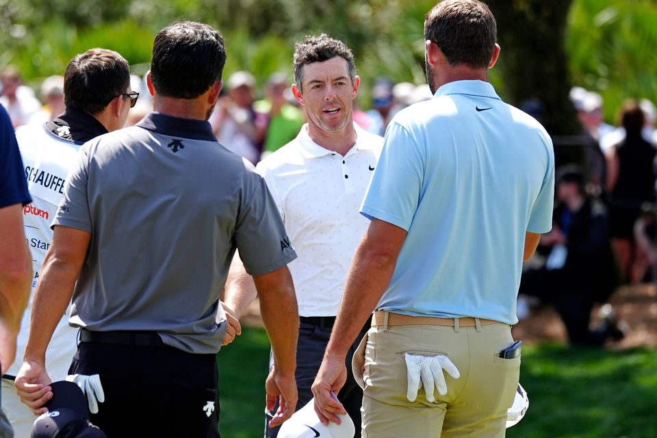 Rory McIlroy shakes hands with Xander Schauffele and Scottie Scheffler at The Players Championship in March. The three will be playing together on the first two days at Quail Hollow. Photo: Getty