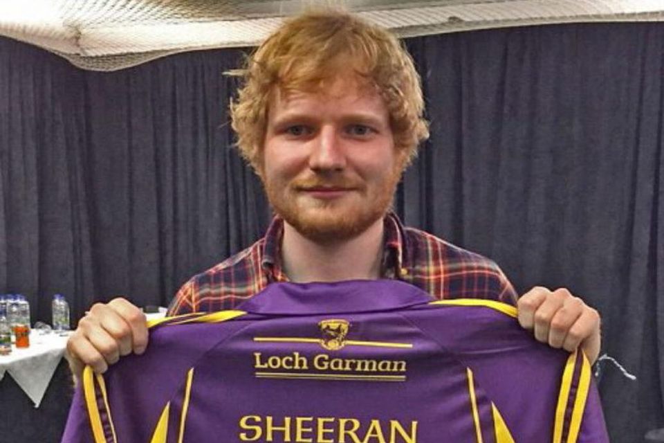 Ed Sheeran holding a Wexford jersey aloft, before later wearing it onstage at Croke Park in front of 80,000 people in 2015.