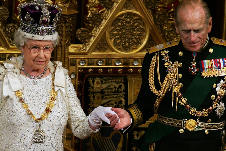 Britiain's Prince Philip (R) takes the hand of Queen Elizabeth II after she addressed politicians at the 'State Opening Of Parliament' in London, 15 November 2006. The British government will publish a long-awaited bill on tackling climate change in the forthcoming session of parliament, Queen Elizabeth II announced Wednesday. One of the key tenets of Prime Minister Tony Blair's final few months in office will therefore involve attempting to set a legacy on slowing global warming -- which his Downing Street office has branded "the biggest long-term threat that we now face."  /WPA POOL/ (Photo by ADRIAN DENNIS / POOL / AFP)        (Photo credit should read ADRIAN DENNIS/AFP/Getty Images)