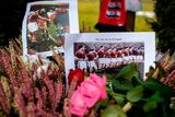thumbnail: A Team photo of the forme Manchester United soccer club and flowers are placed next to a memorial during a commemoration ceremony on the Manchester place at the Munich Riem airport, southern Germany, Tuesday, Feb. 6, 2018. Sixty years ago on Feb. 6, 1958 a plane with professional players of the Manchester United on board crashed in Munich with 21 survivors and 23 fatalities. (Matthias Balk/dpa via AP)