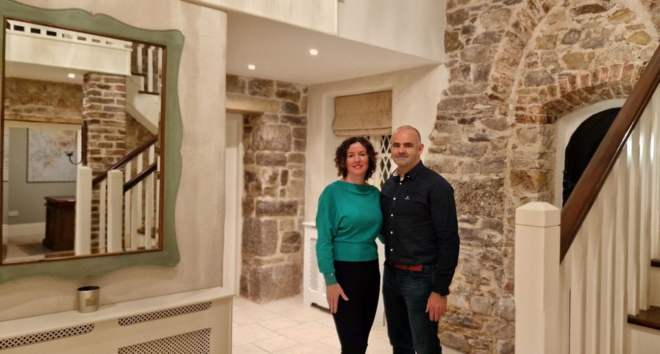 Caroline and Danny in the hall with the restored cut-stone walls