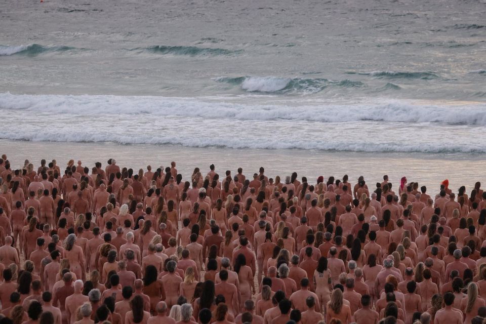 People stand naked as part of artist Spencer Tunick's art installation to raise awareness of skin cancer and encourage people to have their skin checked, at Bondi Beach in Sydney, Australia. Reuters