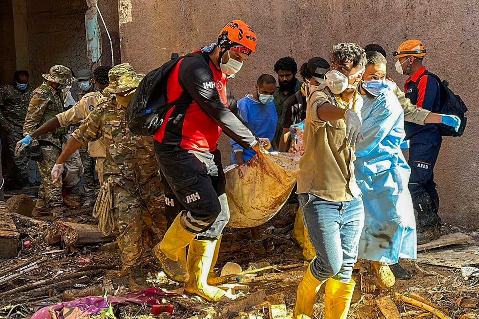 Rescuers retrieve the body of a flood victim in Derna, Libya on Wednesday. Search teams are combing streets, wrecked buildings, and even the sea to look for bodies. Photo: IHH humanitarian aid group/AP