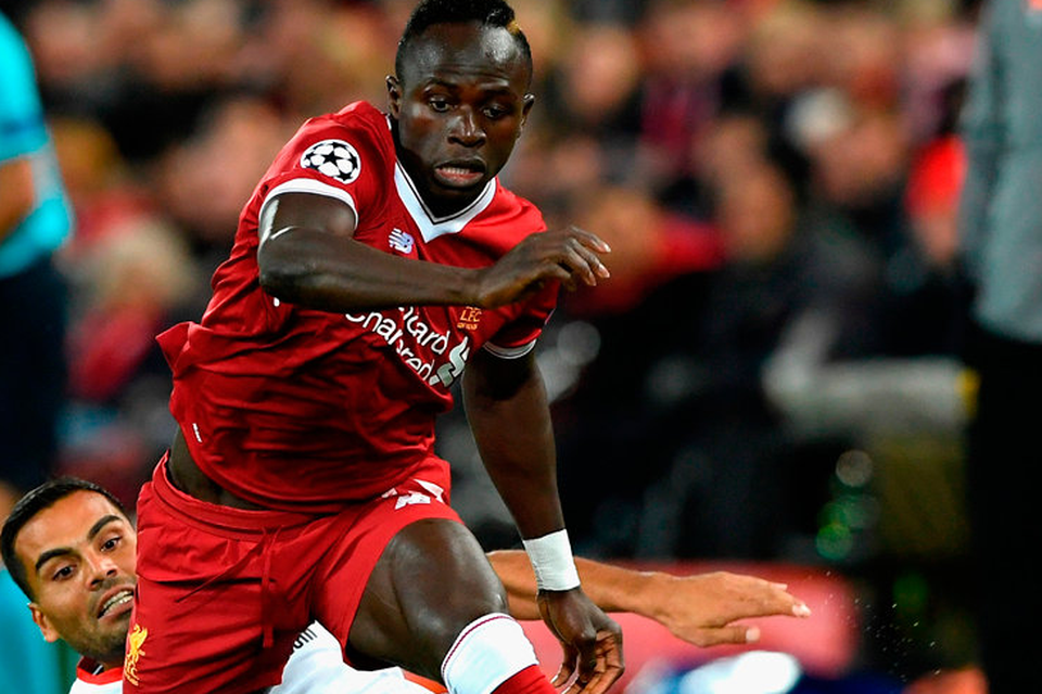 Sadio Mane gets away from Gabriel Mercado during the 2-2 draw at Anfield last night. Photo: Getty Images