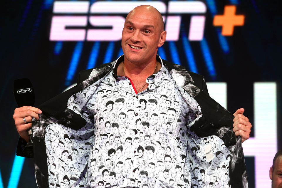 Tyson Fury shows off his shirt which has drawings of former world heavyweight champions on it during the press conference at BT Sport Studio, London (Kirsty O’Connor/PA)